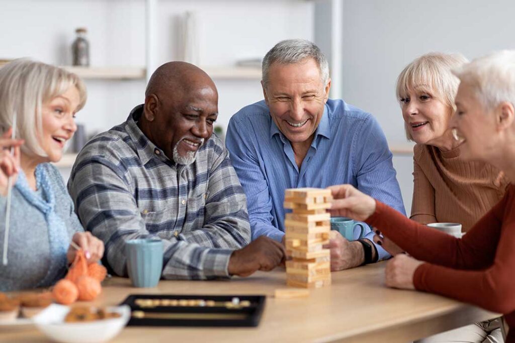 Caregiver reviews a personalized care plan with an older resident at a dining table.