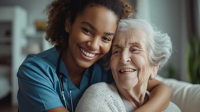 Older adults practice gentle seated movement with a caregiver in a bright assisted living activity room.